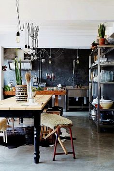 the kitchen is clean and ready to be used for cooking or baking, with plants in pots hanging from the ceiling