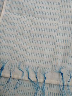 some blue thread is on top of a piece of fabric that has been stitched together