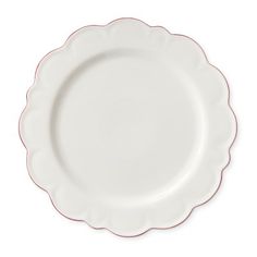 a white plate with red trim on the edge and a round design around the rim