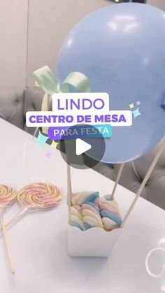 a table topped with lollipops and a blue balloon