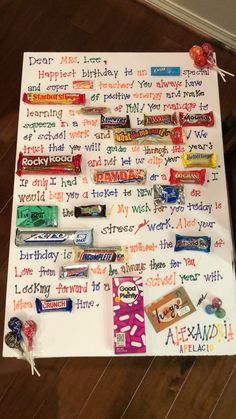 a birthday board with candy bars, candies, and other writing on the paper