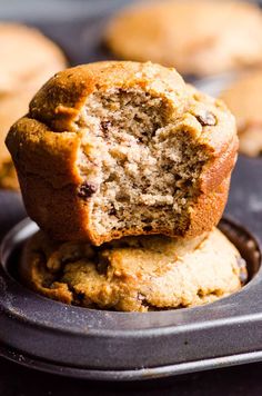 two chocolate chip muffins stacked on top of each other in a muffin tin