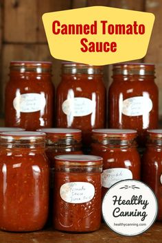 several jars of canned tomato sauce sitting on a table with the words canned tomato sauce above them