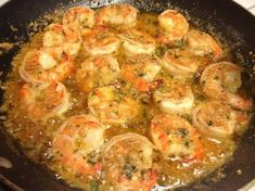 shrimp is cooking in a skillet on the stove