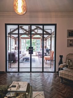 a living room filled with furniture and glass doors