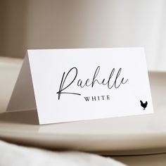 a place card sitting on top of a white plate