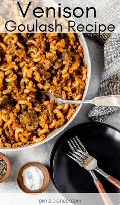 a bowl filled with pasta and sauce next to other ingredients