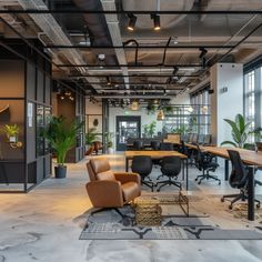 an office with chairs, desks and plants