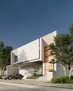 a car is parked in front of a modern house