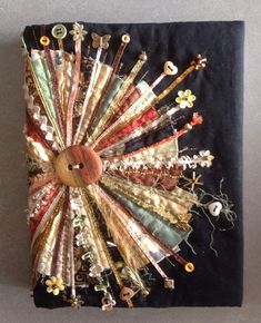 a piece of art made out of fabric and buttons