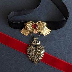 Gothic Heart Pendant on Black Velvet Ribbon Choker Add a touch of romantic gothic elegance to your collection with this Heart Pendant on Black Velvet Ribbon Choker. This Gothic Heart Pendant Necklace features a beautifully detailed Romantic Charm, making it a perfect piece of Chunky Dainty Necklace for women who appreciate the allure of Goth Jewelry. The pendant, crafted from bronze and brass, showcases an intricately designed heart that exudes gothic charm. Adorned with pink tourmaline, the pen Valentine's Day Heart Charm Choker For Party, Valentine's Day Heart Pendant Choker For Party, Adjustable Heart Pendant Choker For Parties, Valentine's Day Party Choker With Heart Charm, Valentine's Day Heart Choker Necklace, Adjustable Heart Charm Choker For Party, Gothic Metal Choker As Gift, Gothic Metal Heart Necklace, Gothic Pendant Choker For Party