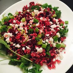 a white plate topped with green and red food