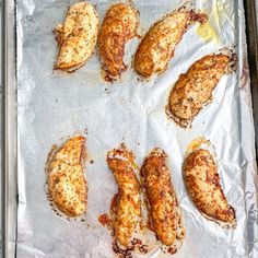 chicken wings on a baking sheet ready to be cooked in the oven for dinner time