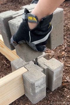 someone is working with cement blocks to build a fire hydrant