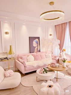 a living room filled with pink furniture and decor on top of hard wood flooring