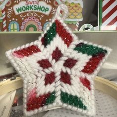 a crocheted christmas star ornament sitting on top of a table