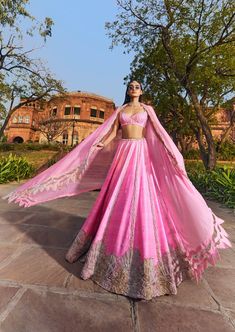 Hot pink raw silk lehenga set with an organza dupatta, embroidered in silver and gold and pearls. Pink Tissue Silk Set With Zari Work, Pink Raw Silk Pre-draped Saree With Dupatta, Pink Tissue Silk Sets With Gota Work, Pink Organza Choli With Gota Work, Pink Art Silk Sets With Sheer Dupatta, Designer Wear Pink Tissue Silk Choli, Pink Raw Silk Gown With Zari Work, Pink Raw Silk Dress With Gota Work, Pink Raw Silk Pre-draped Saree For Reception