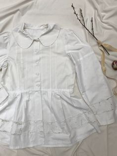 Amazingly detailed vintage 40's/50's blaser or blouse with extreme puff sleeves, peplum and cotton buttons, petern pan collar and cut out lace richelieau with roses. Goes well with an understated crop top and high waisted jeans. Very Rouje-esque, but Eastern European + original. Sits a size small to large. Measurements soon. Excellent condition, rare piece. Cottagecore Long Sleeve Blouse With Lace Collar, Vintage Cotton Blouse With Lace Cuffs, Vintage Spring Tops With Lace Trim, Vintage Fitted Tops With Broderie Anglaise, Vintage Fashion Lace Trim Tops For Spring, Cotton Cottagecore Top With Doll Collar, Spring Vintage Fashion Tops With Lace Trim, Vintage Lace Trim Tops For Spring, Fitted Button-up Blouse With Lace Cuffs