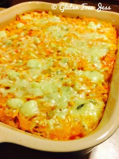 a casserole dish with cheese and broccoli in it on a table