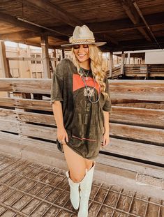 Treat yourself to some wild style with our Stay Wild T Shirt Dress! Perfect for the country concert or festival look, it's a midnight black vintage mineral stone wash for extra flair. And you'll be singing stars and stripes with 100% USA-grown cotton pre-shrunk for patriotic pride. Don't forget your shorts though—dancing outside means you don't want to give anyone a free moon view! ;)Grab your Stay Wild T Shirt Dress now! SIZE: TOTAL LENGTH | CHEST WIDTH | SLEEVE WIDTHSMALL 30" 22" 9.5"MED 31" 2 Bun B Concert Outfit, Duelo Concert Outfit, Dress For A Country Concert, Country Rock Concert Outfit Plus Size, Food Truck Festival Outfit, T Shirt Dress With Cowgirl Boots, Cute Nashville Outfits Summer Going Out, Oversized Tshirt Dress Outfit Western, Niko Moon Concert Outfit