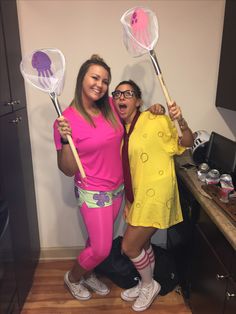 two women are posing for the camera while holding up their paddles in front of them