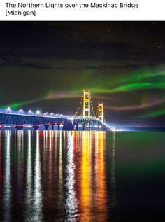 the northern lights over the macknac bridge are reflected in the water at night time