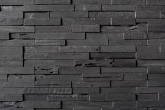 a black brick wall that is made out of wood