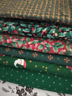 a stack of christmas fabric with santa claus on it