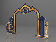 an arch decorated with gold and blue decorations on top of a reflective surface in front of a gray background