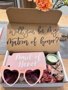 a box filled with pink heart shaped sunglasses and a sign that says, will you be my matron of honor?