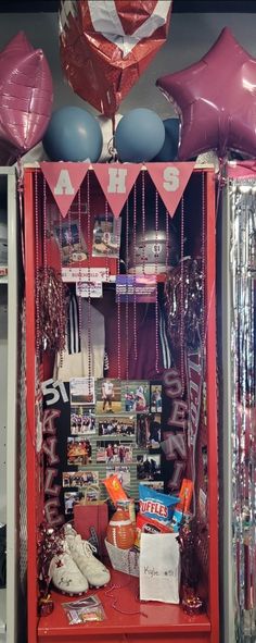 a red locker with balloons and other items