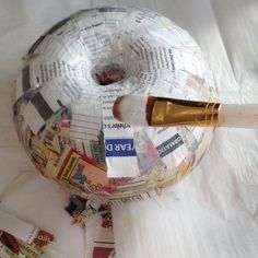 an apple made out of newspaper and a wine bottle