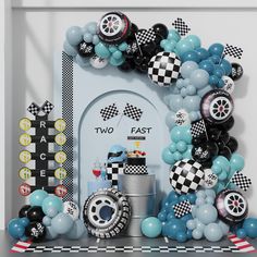 a birthday party with balloons and race themed decorations on the fireplace mantelpieces