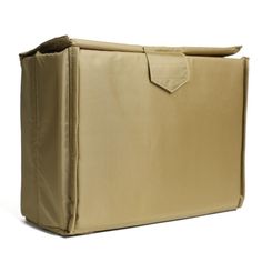 the back side of a tan bag with an open pocket on it's side