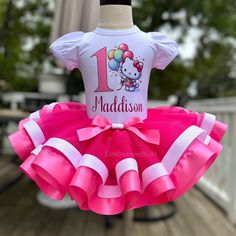 a hello kitty birthday outfit with pink and white ruffles