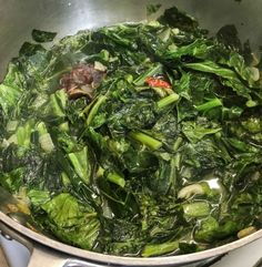 spinach and other vegetables cooking in a pot