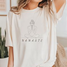 This Namaste Yoga T-Shirt is a peaceful and calming addition to your wardrobe. A perfect zen meditation gift. Made with 100% Airlume combed and ring-spun cotton, this lightweight and breathable tee is perfect for both active yoga sessions and leisure wear. The ribbed knit collar and shoulder tape provide structural support, while the tear-away label minimizes skin irritation. The retail fit and classic crew neckline make it suitable for casual and semi-formal settings, adding a touch of zen to y Comfortable Cotton T-shirt For Relaxation, Short Sleeve Athleisure Tops For Relaxation, Relaxed Short Sleeve Tops For Relaxation, Casual Short Sleeve Relaxed Top, Relaxed Short Sleeve T-shirt For Relaxation, Cotton Relaxed Fit Top For Meditation, Relaxed Fit Crew Neck T-shirt For Relaxation, White Athleisure Tops For Relaxation, Relaxed Cotton T-shirt For Casual Wear