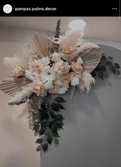 a bouquet of flowers hanging on the wall next to a mirror with text that reads, pampas palms decor