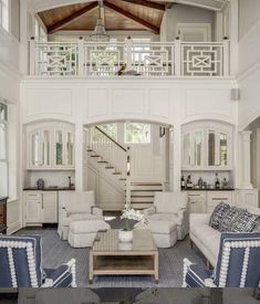 a living room filled with furniture next to a staircase