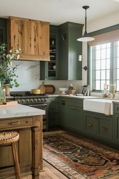 a kitchen with green cabinets and an area rug in front of the stove top oven