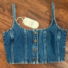 Brand New W/ Tags!! This Is The Cutest Lil Denim Crop! It Has Adjustable Straps And The Quality Is Amazing!! Size Small! I Wear A 34b And This Small Fits Perfect For Reference;)) I Should Be Getting More Sizes In Soon! *Feel Free To Ask Any Questions!! *Made By The Australian Company Ghanda But I’m Listing Under Free People Because Such A Similar Style/Vibe! Summer Dark Wash Tops With Button Closure, Dark Wash Button Closure Top For Summer, High Rise Denim Crop Top Casual Style, High Waist Denim Crop Top In Medium Wash, Casual Cropped Medium Wash Denim Top, Trendy Medium Wash Crop Top, Summer Cropped Denim Top With Button Closure, High Rise Cotton Crop Top For Spring, Spring Cotton Crop Top