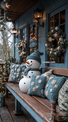 a snowman sitting on top of a wooden bench