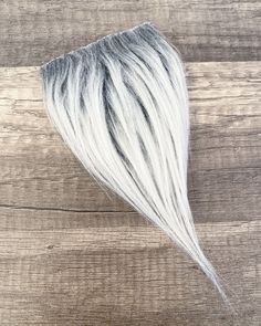 white and grey hair on wooden background