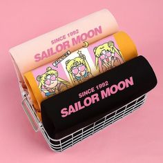 the sailor moon tube holder is holding three rolls of sailor moon paper in it's holder