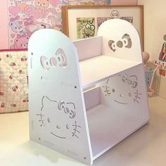 a child's desk with hello kitty cutouts on the top and bottom shelf