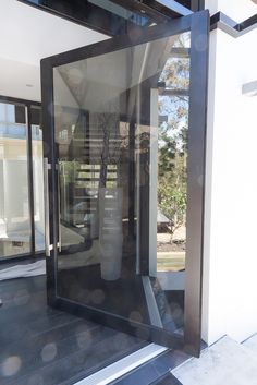 an open glass door on the side of a building