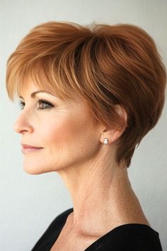 Layered Pixie with Volume Hairstyle on a woman in her 50s with short copper brown hair, side view.