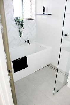 a bathroom with a white bath tub next to a toilet