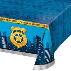 a blue table cover with a police badge on it and city lights in the background