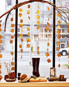 an instagram page with autumn leaves and boots on the table in front of a window